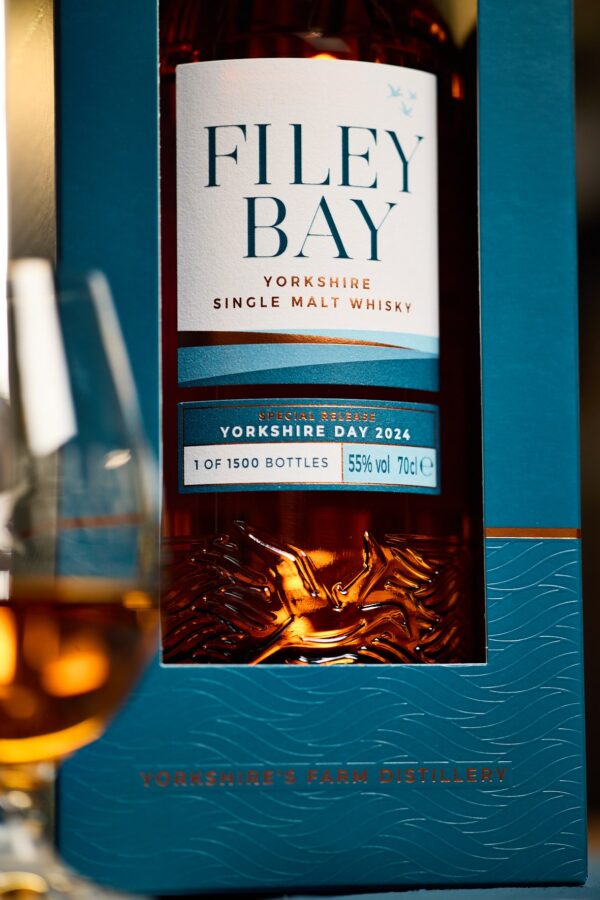 Close up of the Filey Bay Yorkshire Day 2024 bottle inside the new Special Release carton, with waves debossed and 'Yorkshire's Farm Distillery' highlighted in copper.
